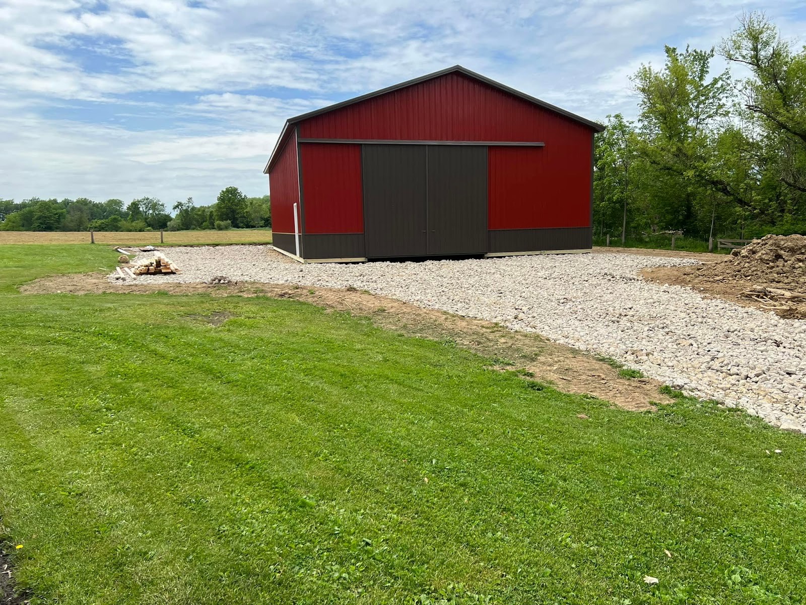 New red pole barn on a graded lot