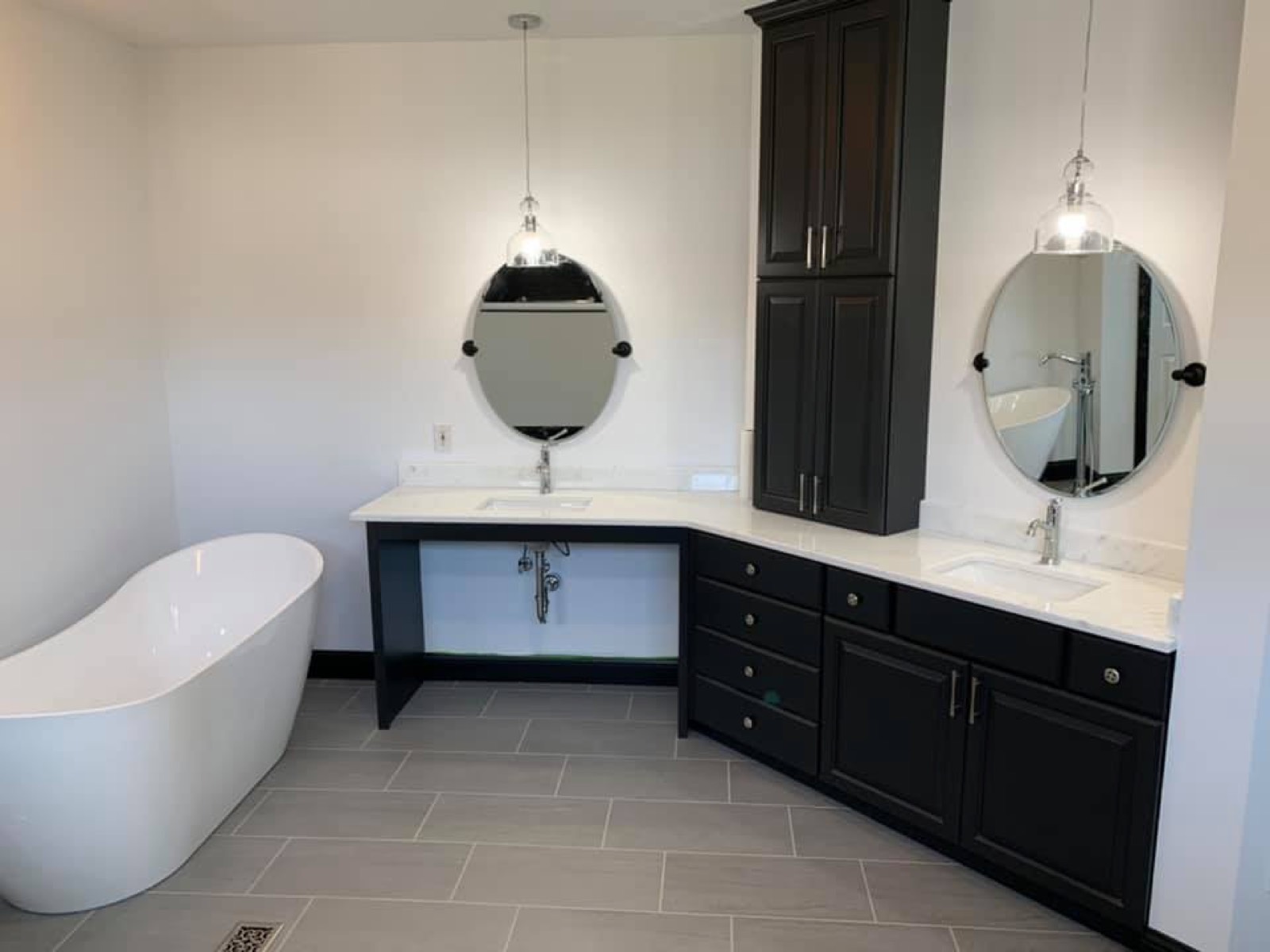 Remodeled bathroom with freestanding tub and wood-plank ceiling