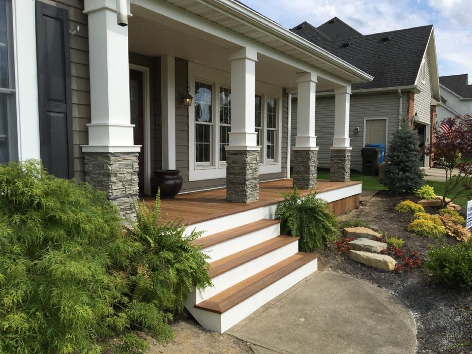 Deck with white steps beside a home