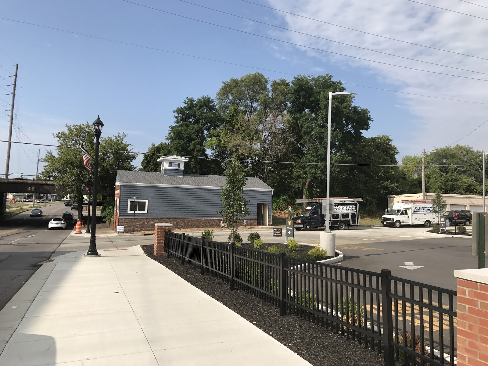 Home with a new black fence and driveway