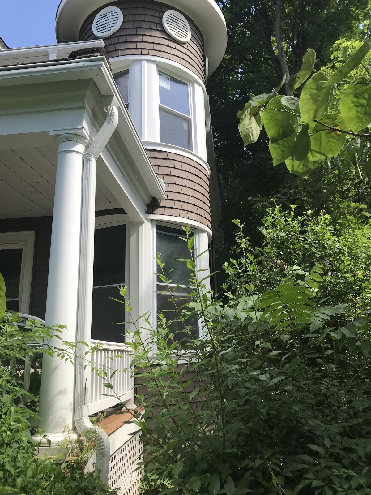 Home with a columned porch and round turret room
