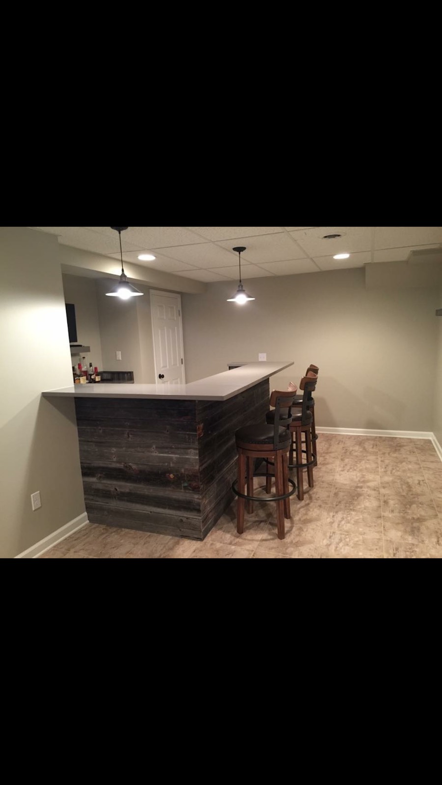 Kitchen and bar area with dark cabinets and seating