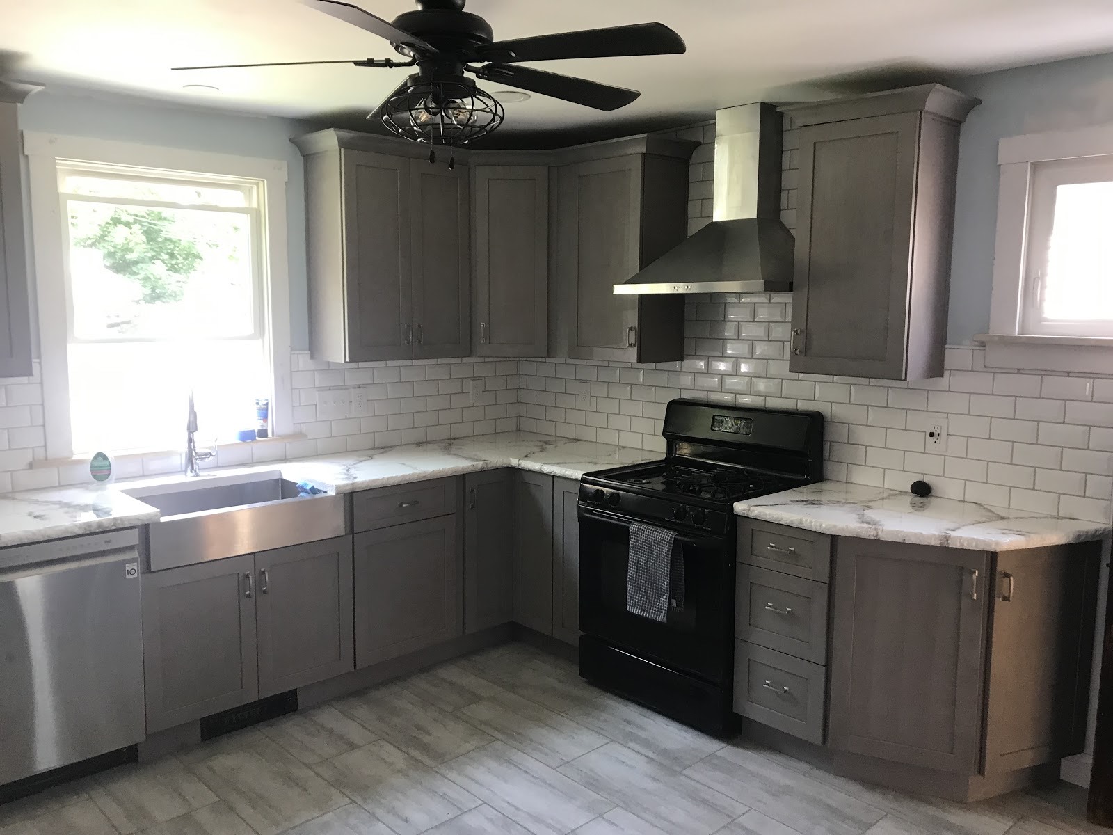 Remodeled kitchen with grey cabinets and subway tile